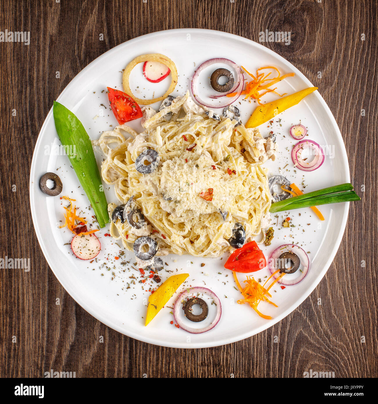 Alfredo pasta spaghetti with olives chicken cream sauce Stock Photo