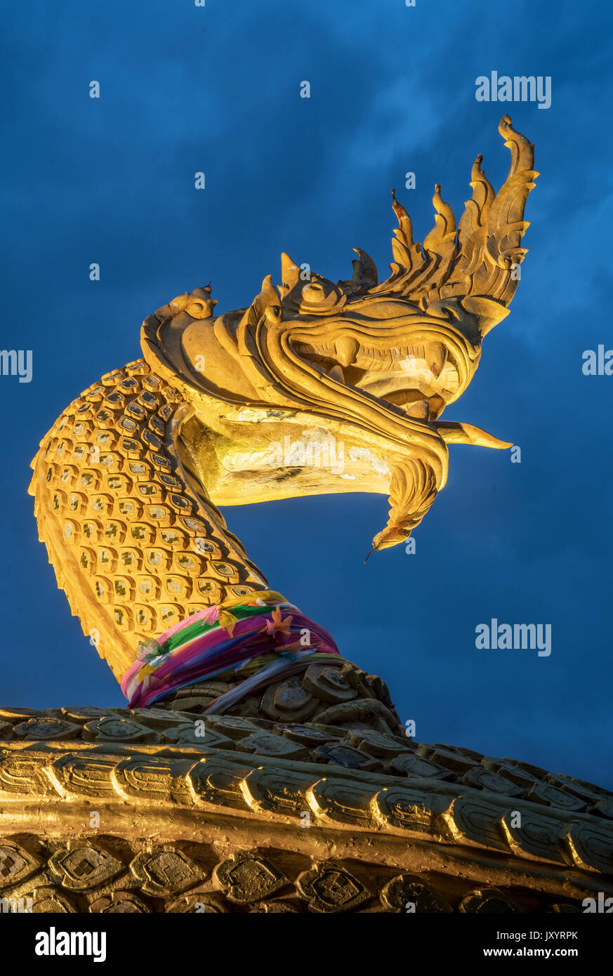 Ornate golden snake statue under cloudy sky Stock Photo Alamy