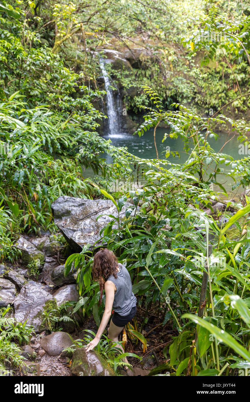 Woman hiking to remote waterfall Stock Photo