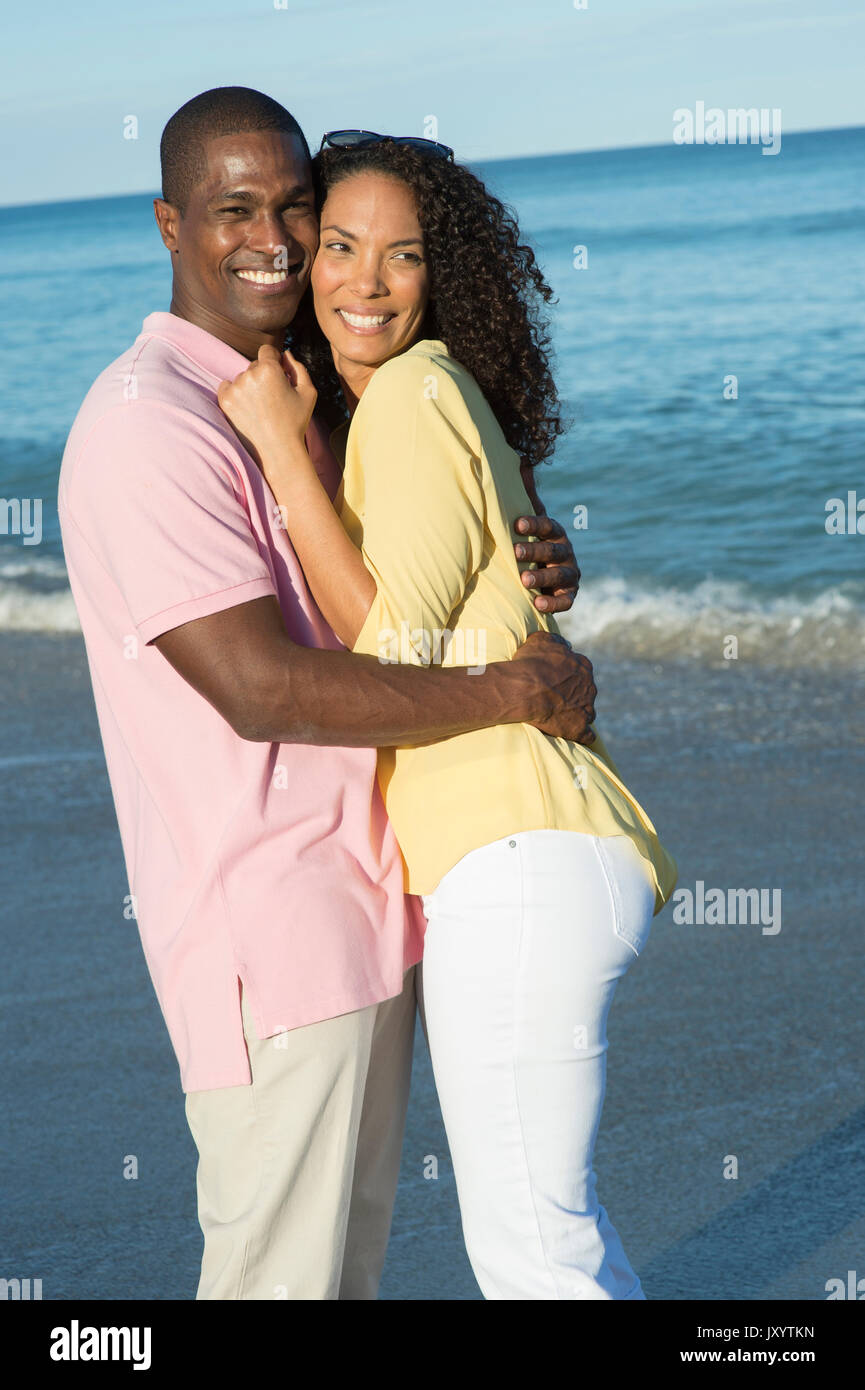 Portrait of couple hugging on beach Stock Photo