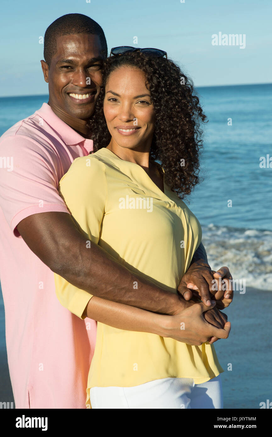 Smiling couple hugging on beach Stock Photo