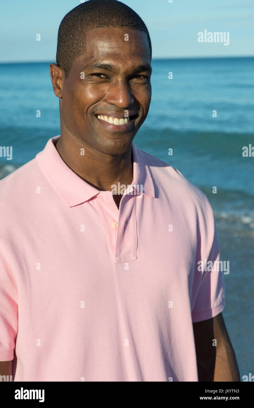 Portrait of smiling Black man on beach Stock Photo