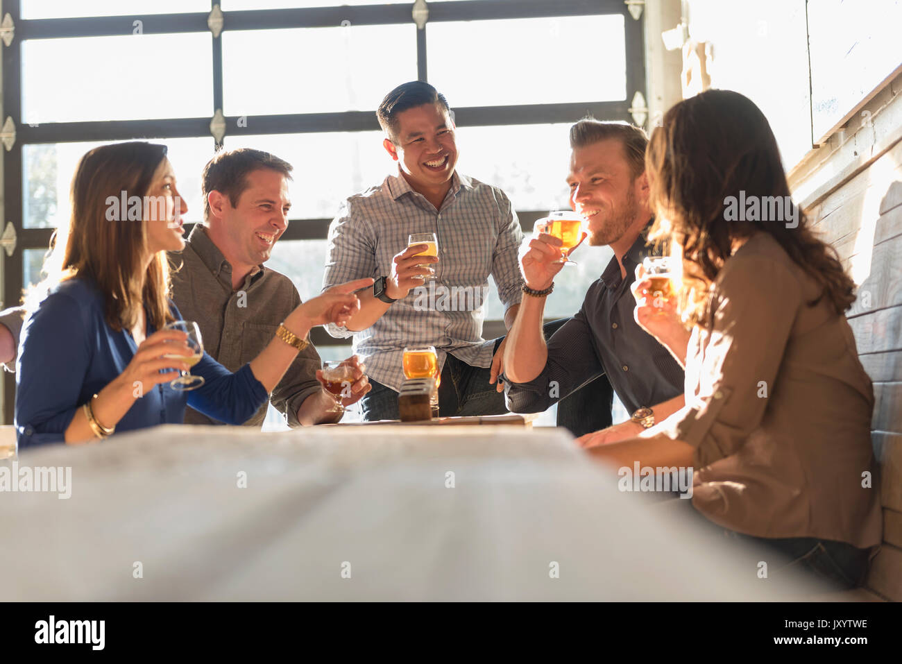Friends drinking beer in brew pub Stock Photo