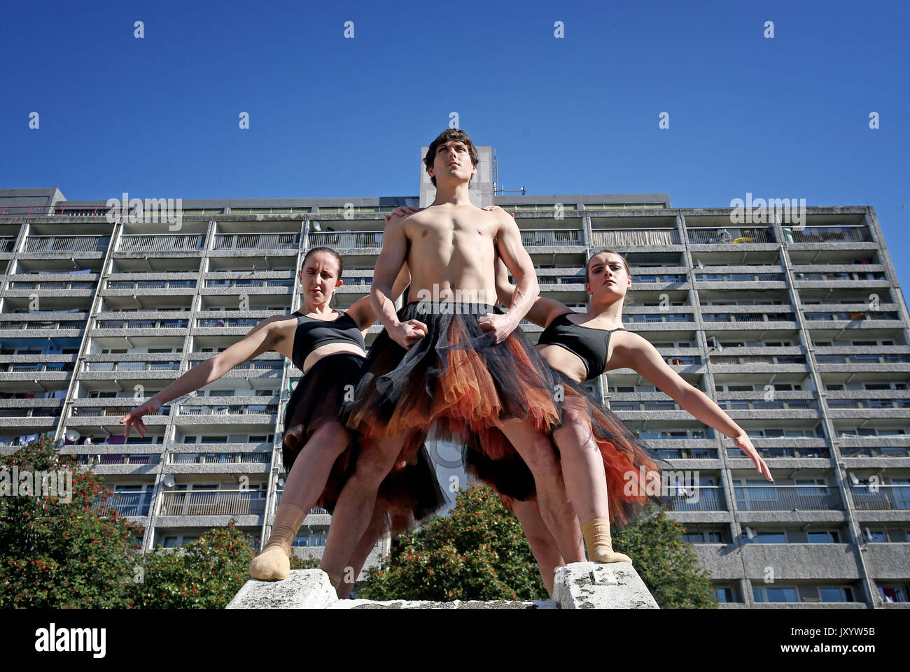 Dancers (from left) Charlotte Mclean, Oscar Perez and Shannon Dray, from the Scottish Dance Theatre, perform part of their gritty urban Festival show TutuMucky in front of the Links View House scheme in Leith, Edinburgh. Stock Photo
