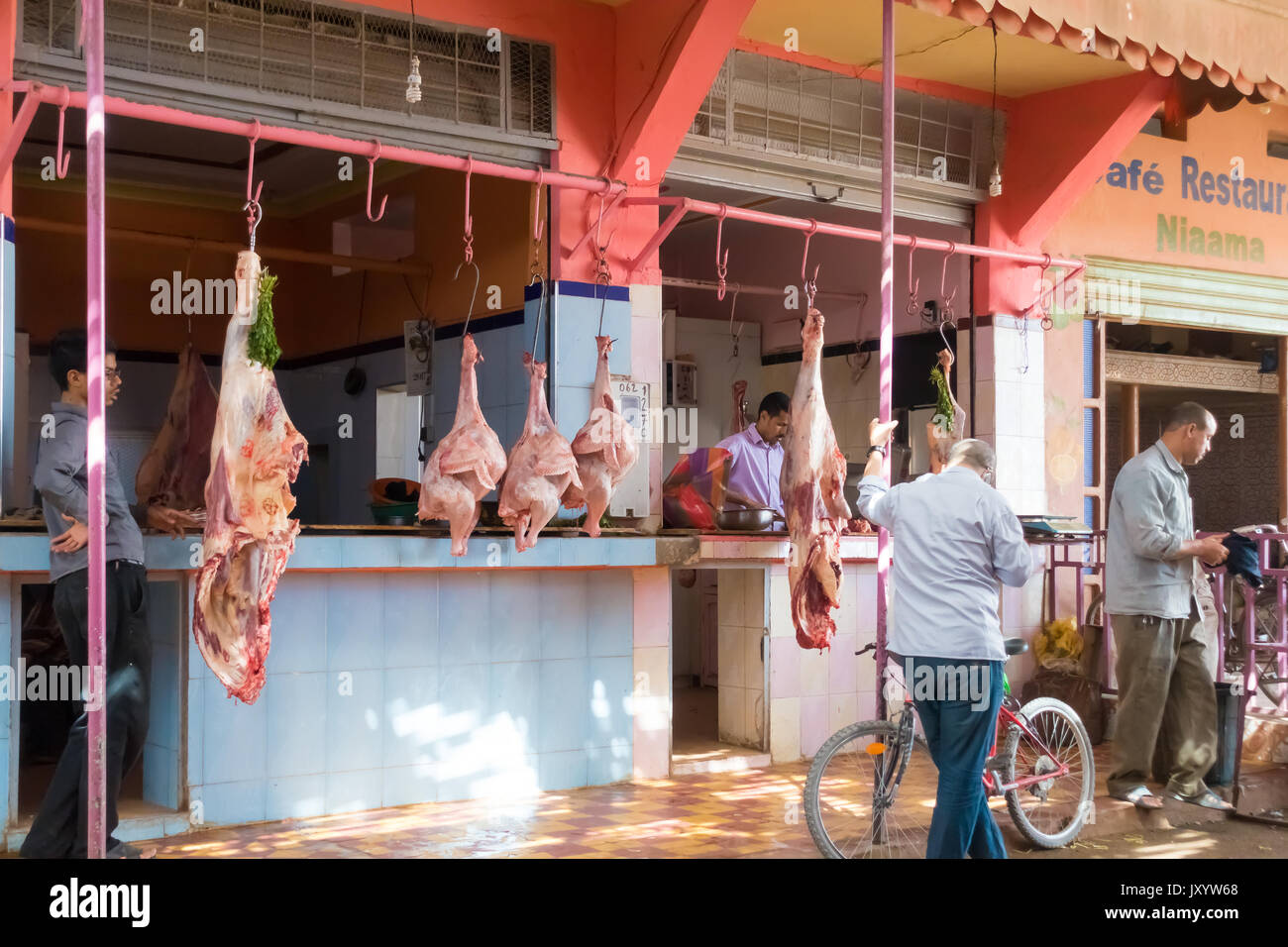 Rissani, Morocco - May 09, 2017: Local moroccan customers standing in the morning in front of the butcher shop at the market in Rissani, Morocco, wait Stock Photo