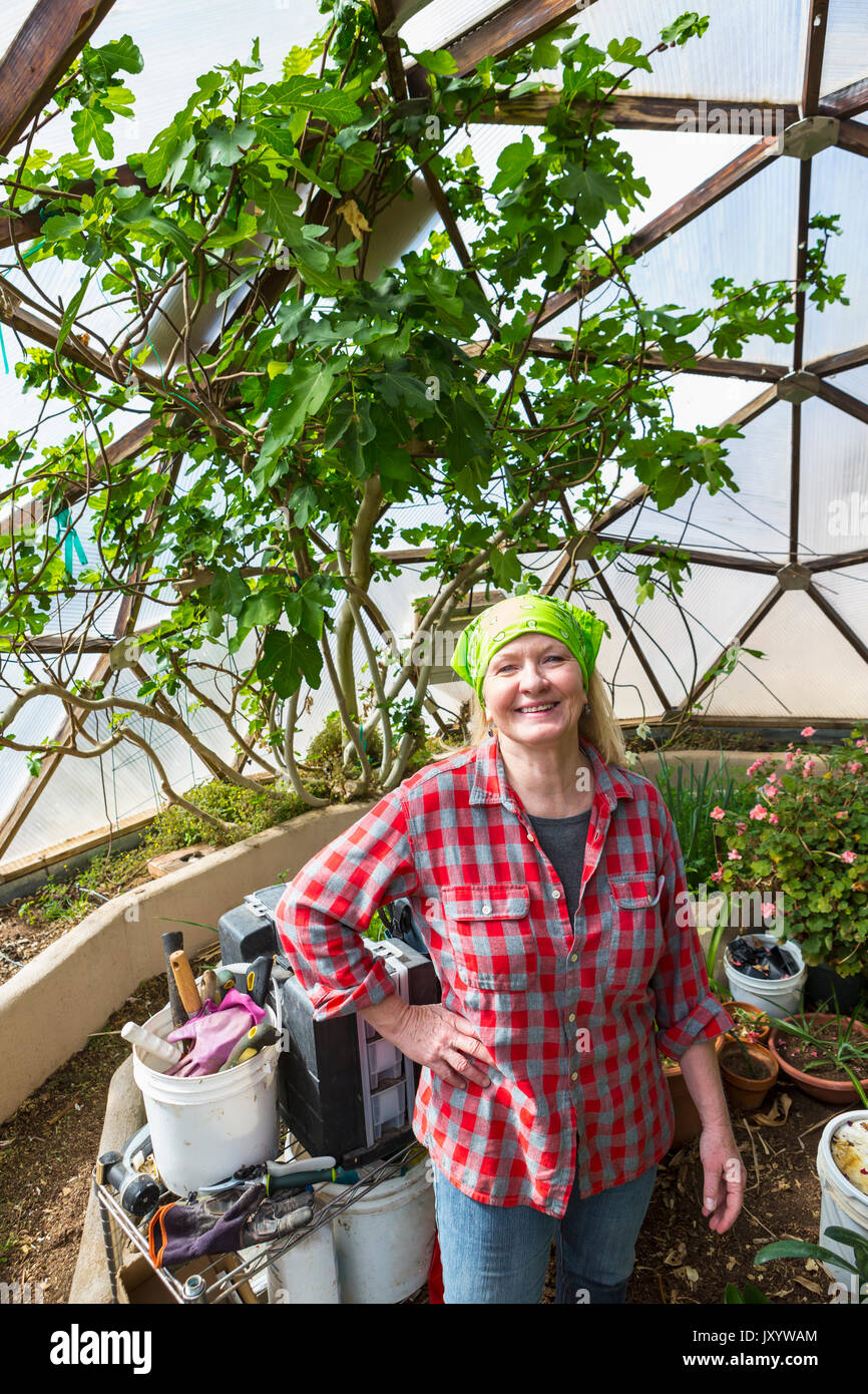 Caucasian woman gardening in greenhouse Stock Photo