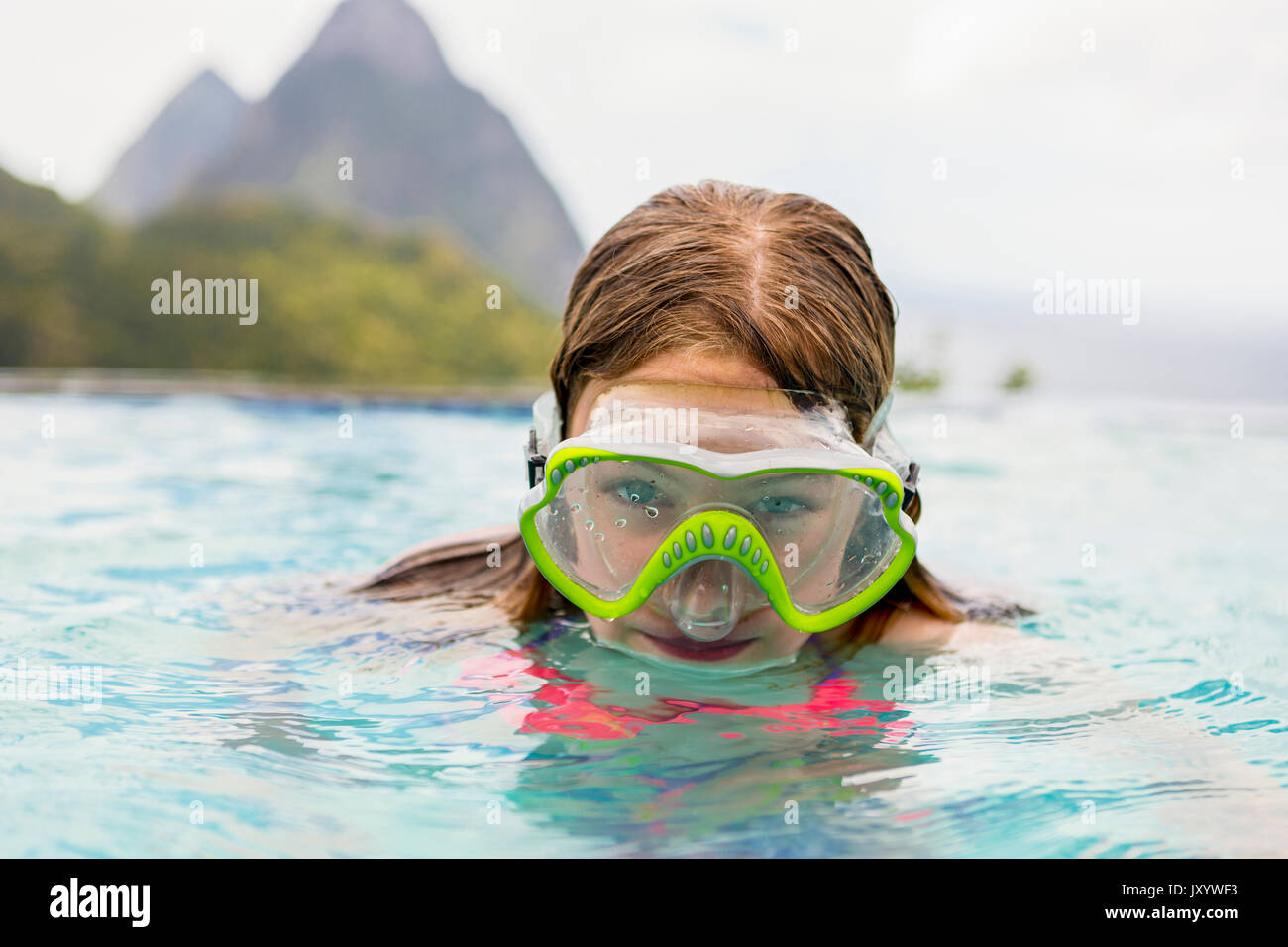 Caucasian girl wearing snorkel mask in swimming pool Stock Photo