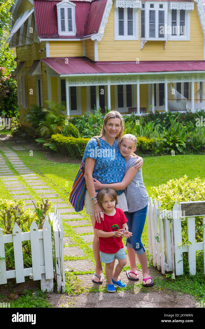 Caucasian mother with son and daughter in front view house Stock Photo