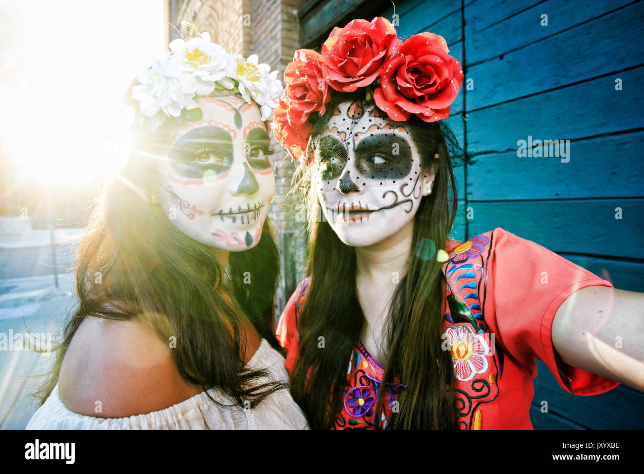Women on sidewalk wearing skull face paint Stock Photo