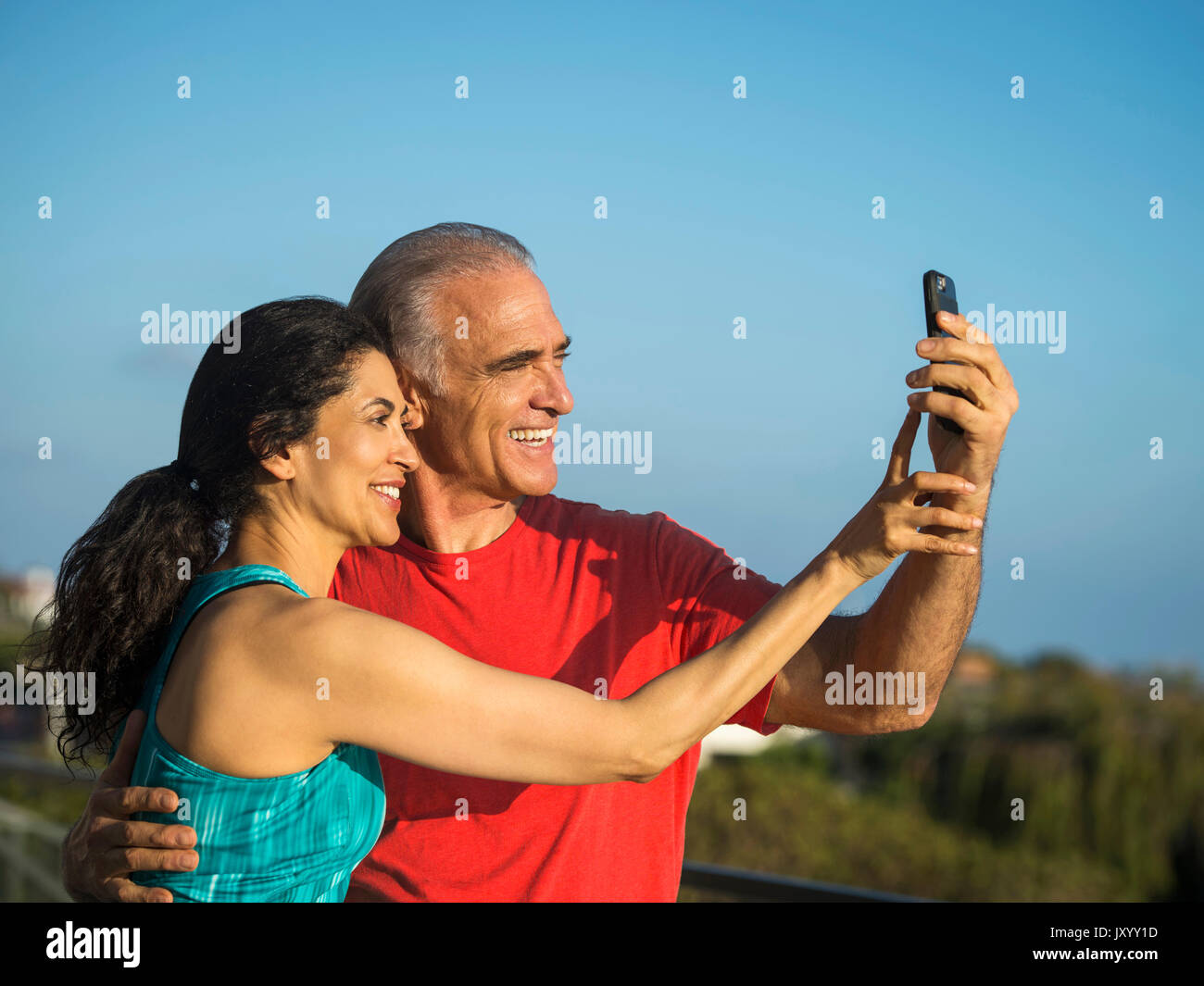 Older couple posing for cell phone selfie Stock Photo - Alamy