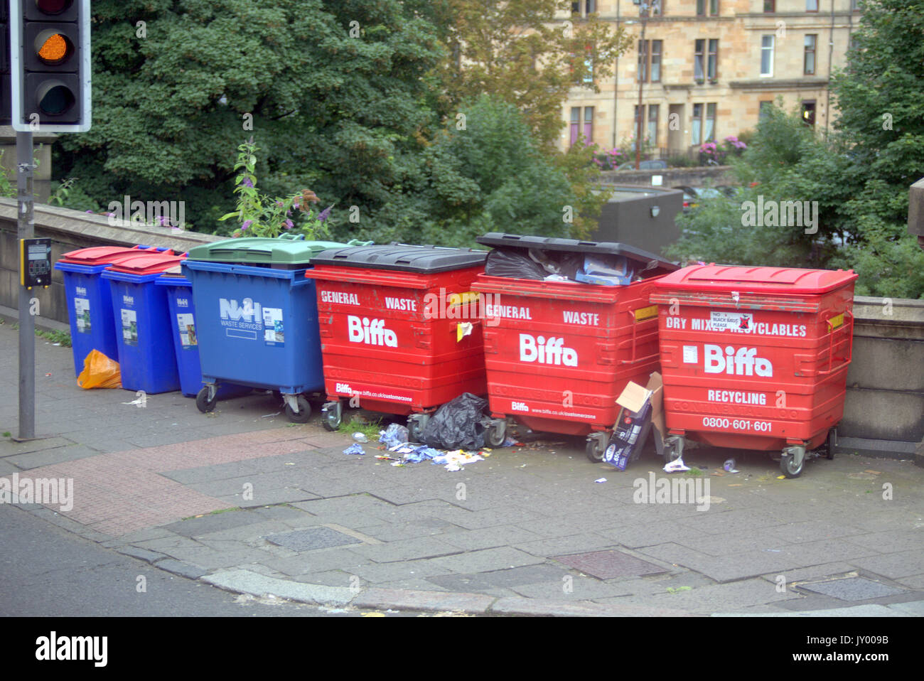Kelvinbridge line of skips or dumpsters bins Biffa  om the bridge used by local businesses Stock Photo
