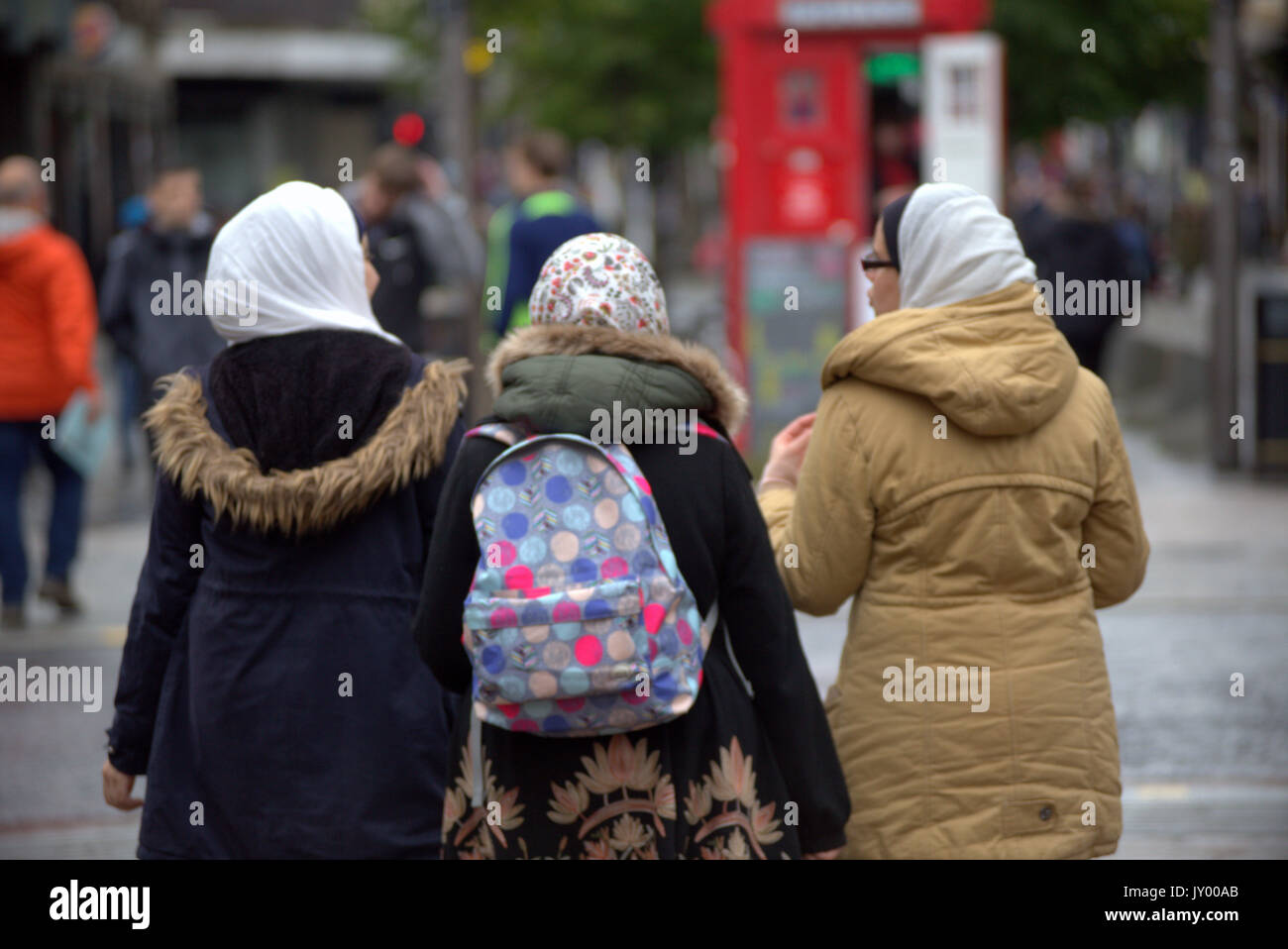 three 3 young Asian woman with hijab scarf viewed from behind Stock Photo