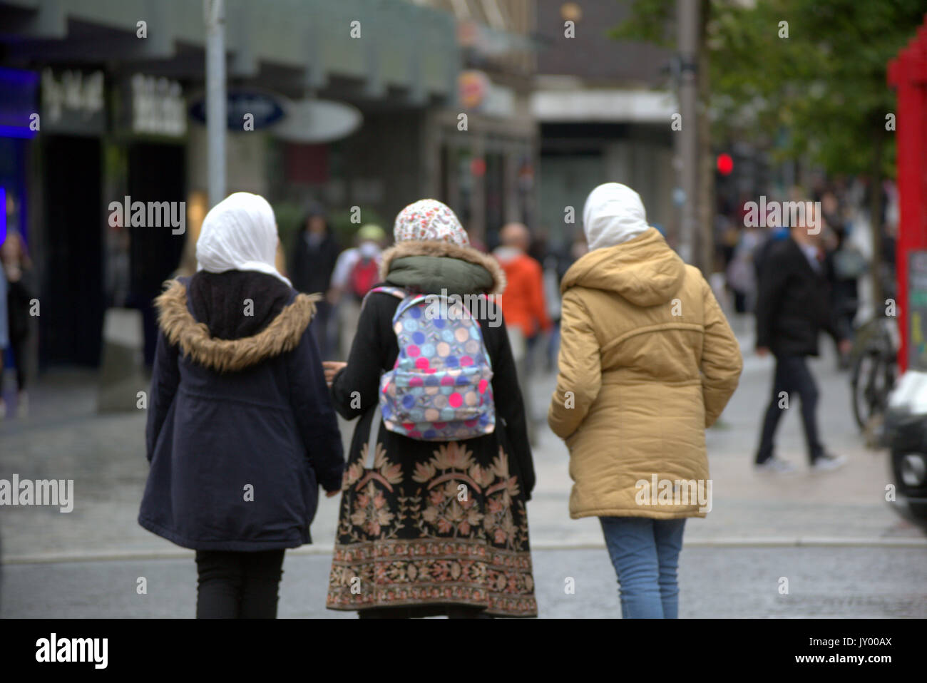 three 3 young Asian woman with hijab scarf viewed from behind Stock Photo