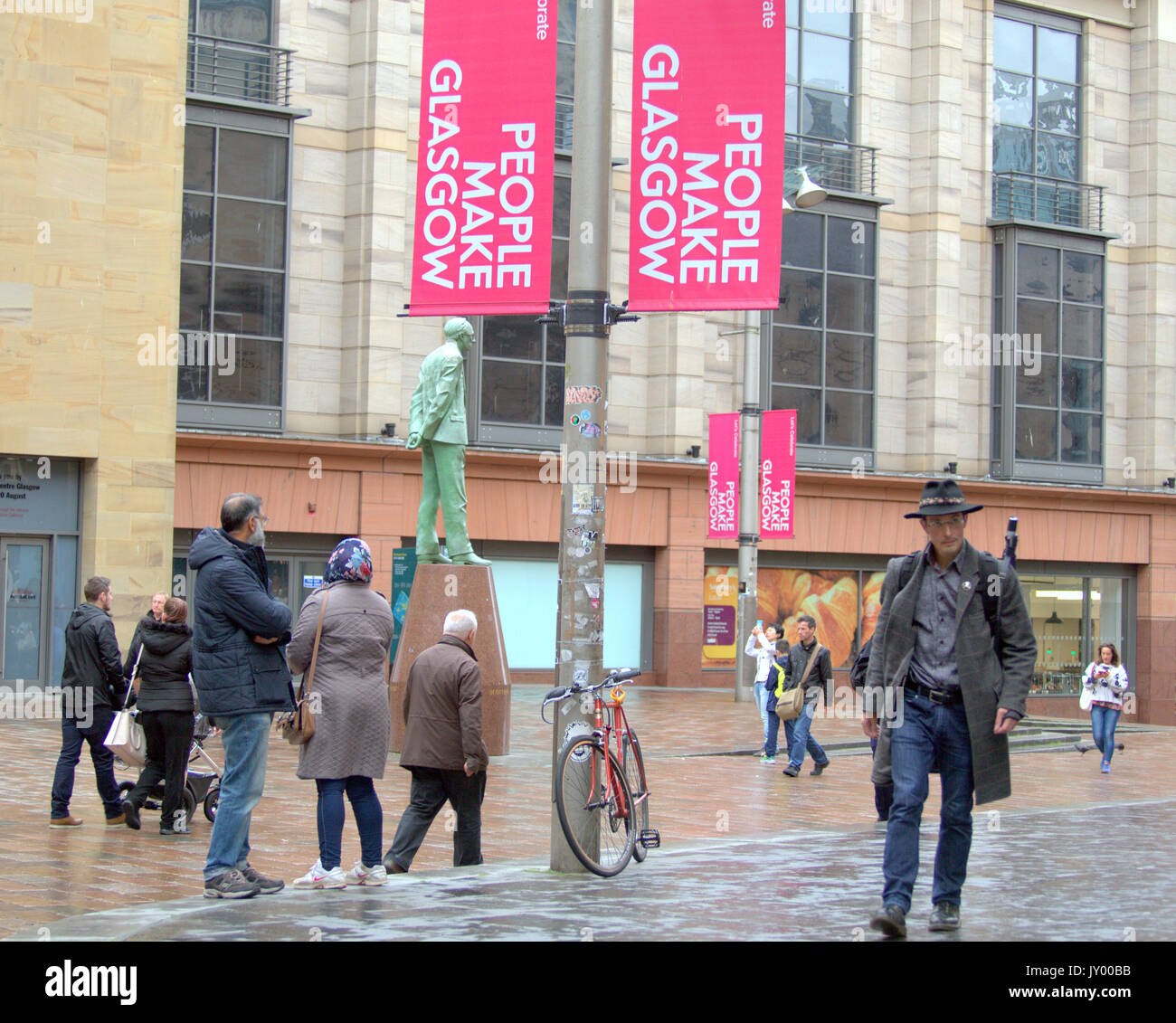 Buchanan street shopping area Donald Dewar statue  Asian included  people make Glasgow sign everyday shopping street scene crowds Stock Photo