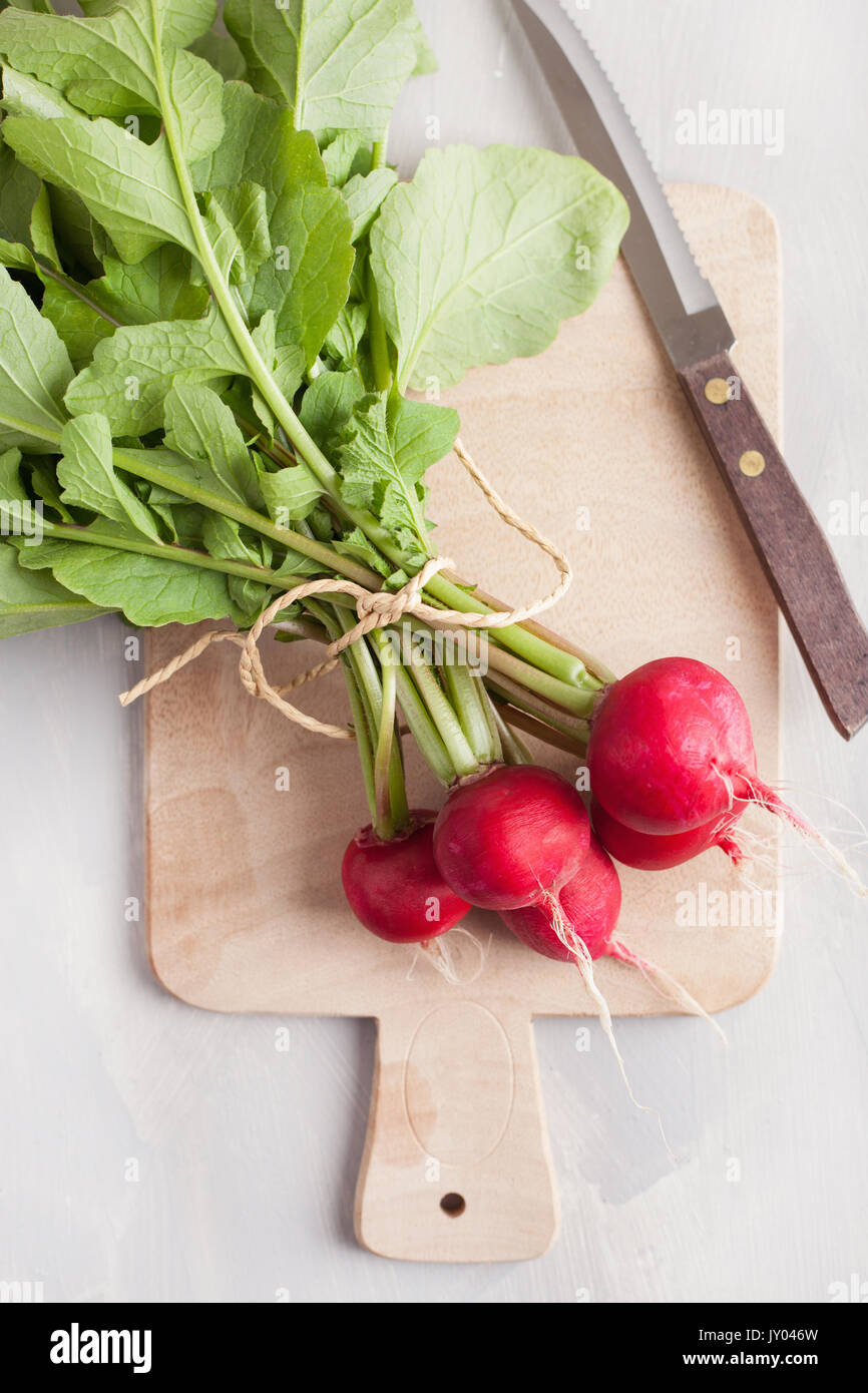 fresh raw radish with leaves over gray background Stock Photo Alamy