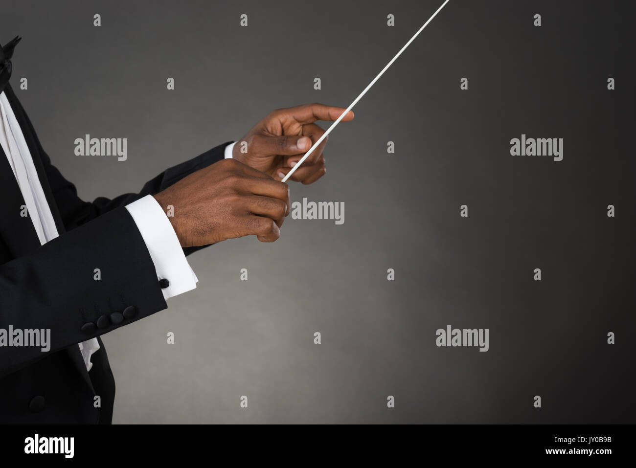 Close-up Of Music Conductor Hands Holding Baton Stock Photo
