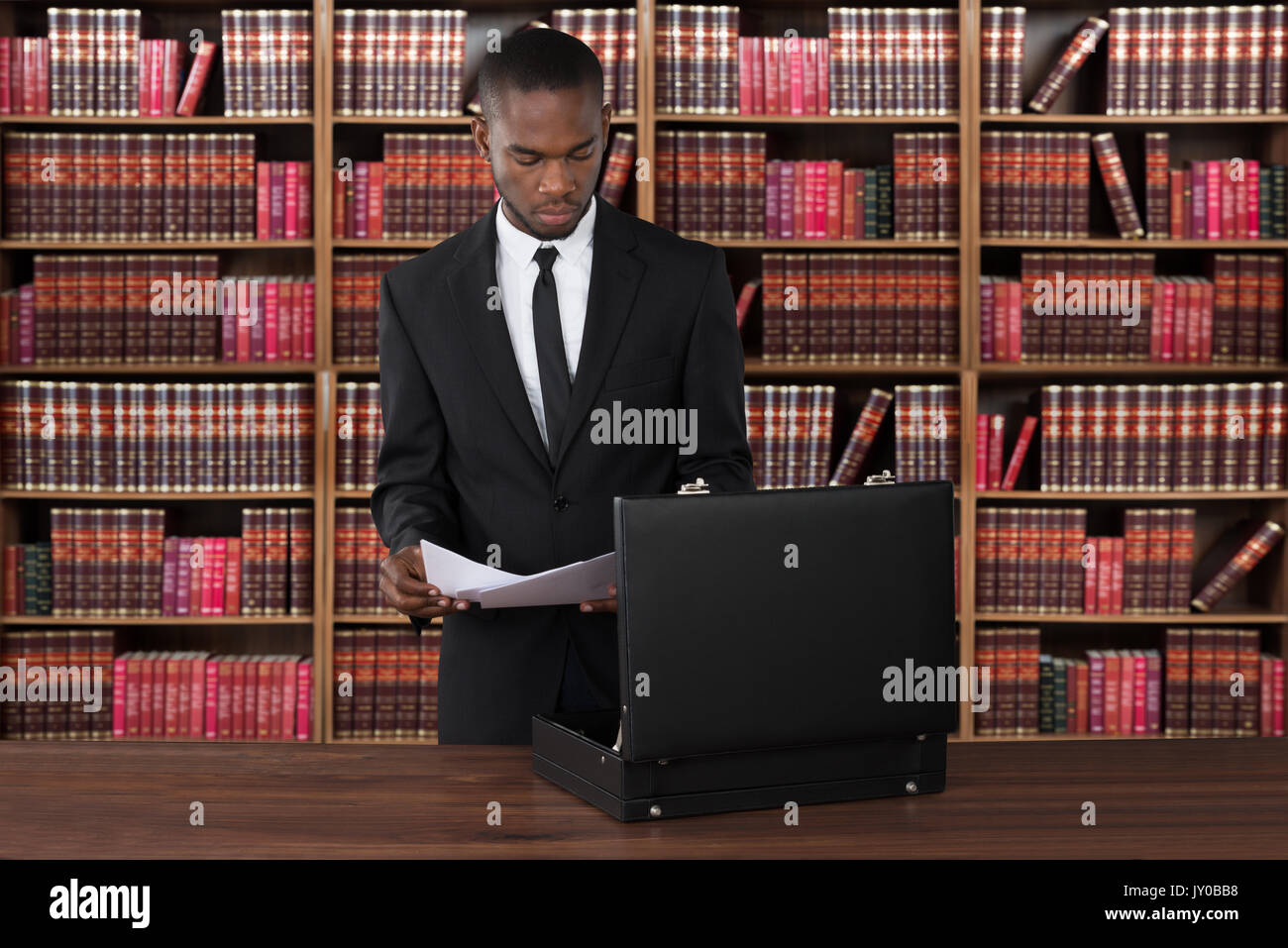 Male Lawyer With Papers And Briefcase At Desk In Office Stock Photo Alamy