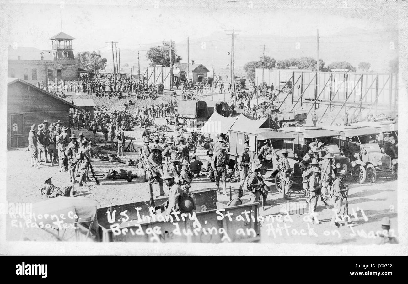 Group shot of many African American members of the US Infantry, outside and amongst tents, buildings, and equipment, at the International Bridge in El Paso, Texas during the Battle of Juarez, Texas, June, 1919. Stock Photo