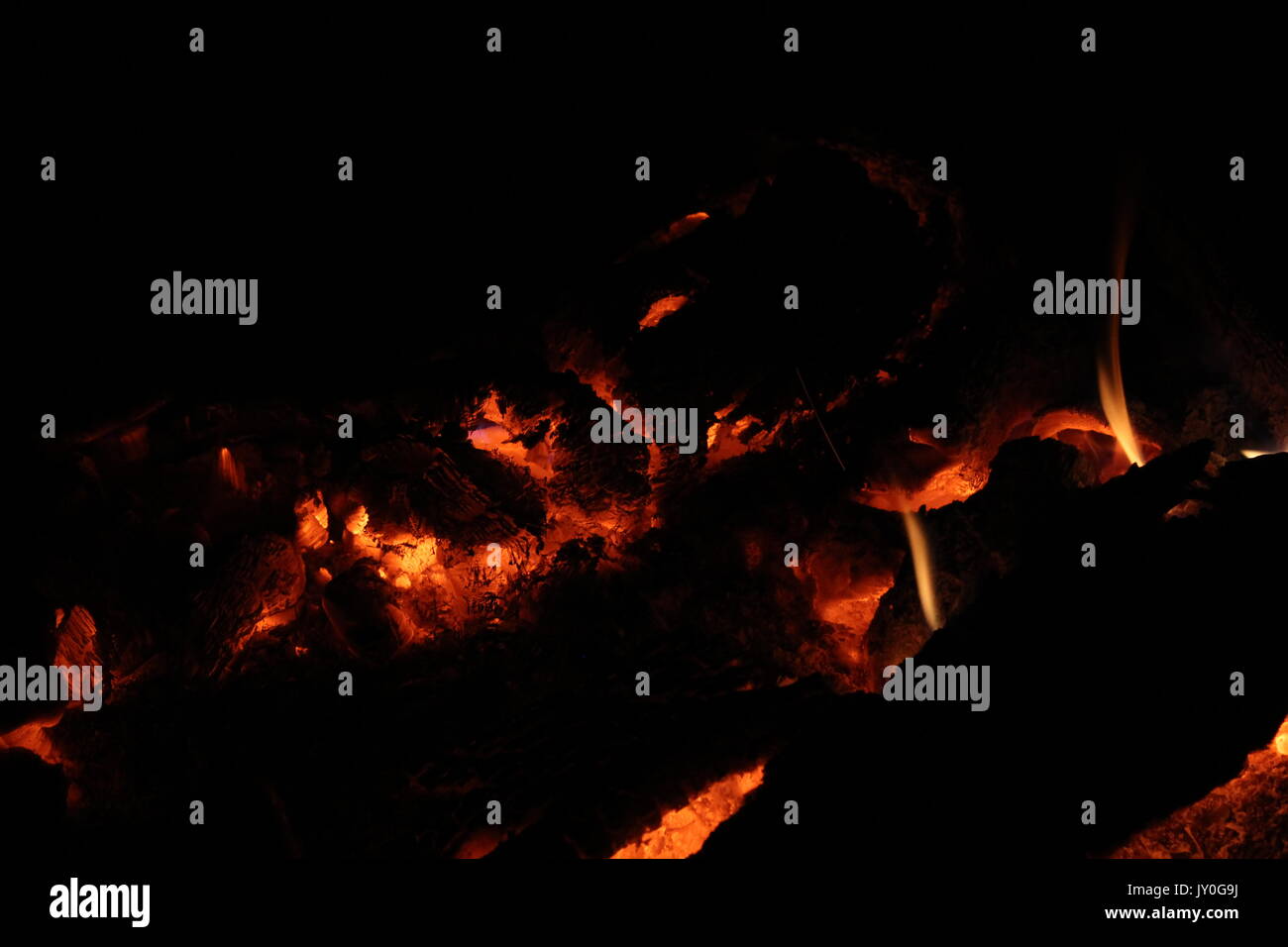 Hot coals is what is left of a settling old fire. Stock Photo