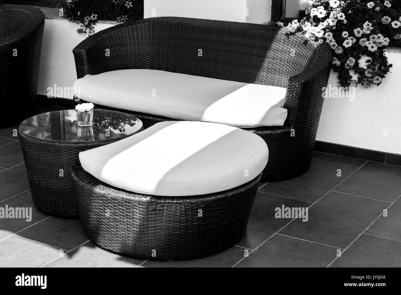 Wicker furniture in lounge area for relax at day in black and white Stock Photo