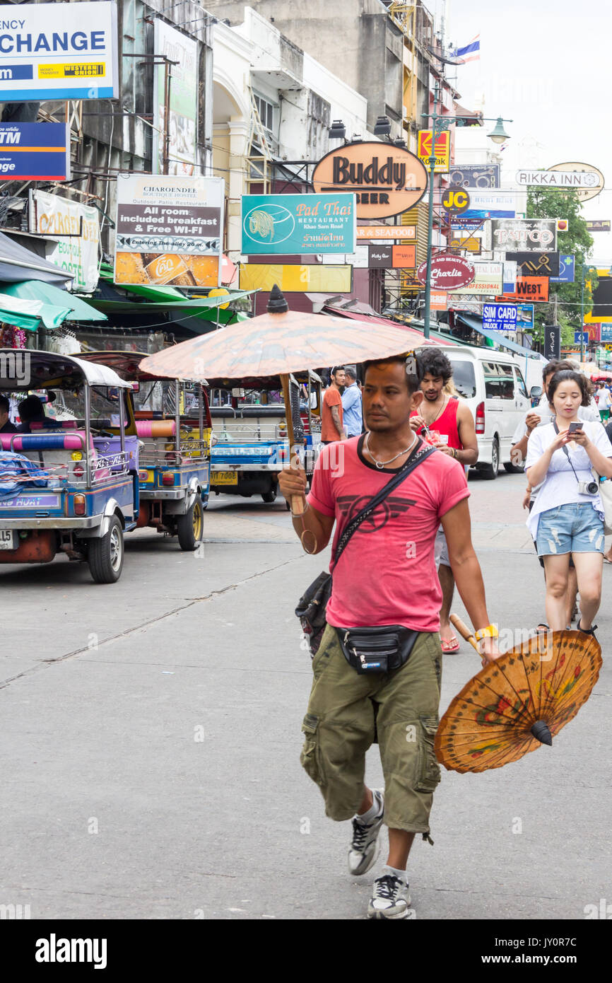 Man selling umbrellas on Khao San road, Bangkok, Thailand Stock Photo