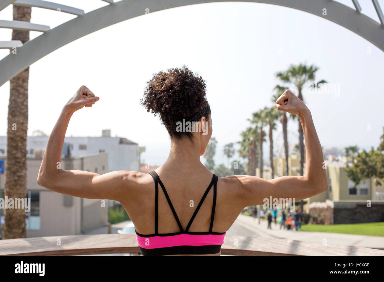 Mixed Race woman flexing arms Stock Photo
