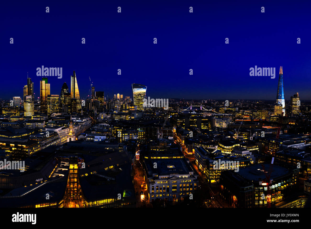 UK, London, Aerial view over the city at night, with view of the financial district, Tower Bridge, Canary Wharf and the Shard Stock Photo