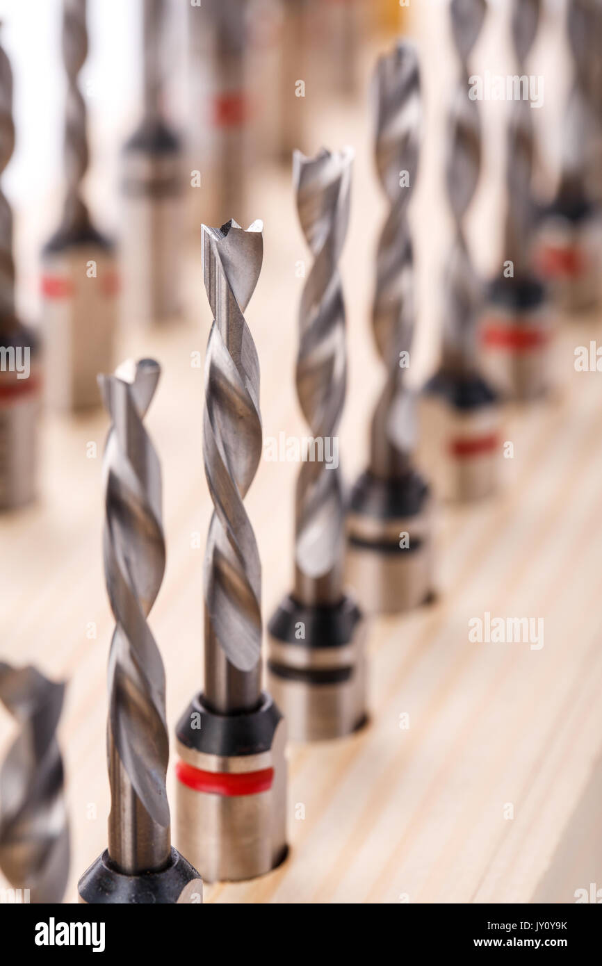 various shapes drill bits for wood on wooden stand. close-up macro photo Stock Photo