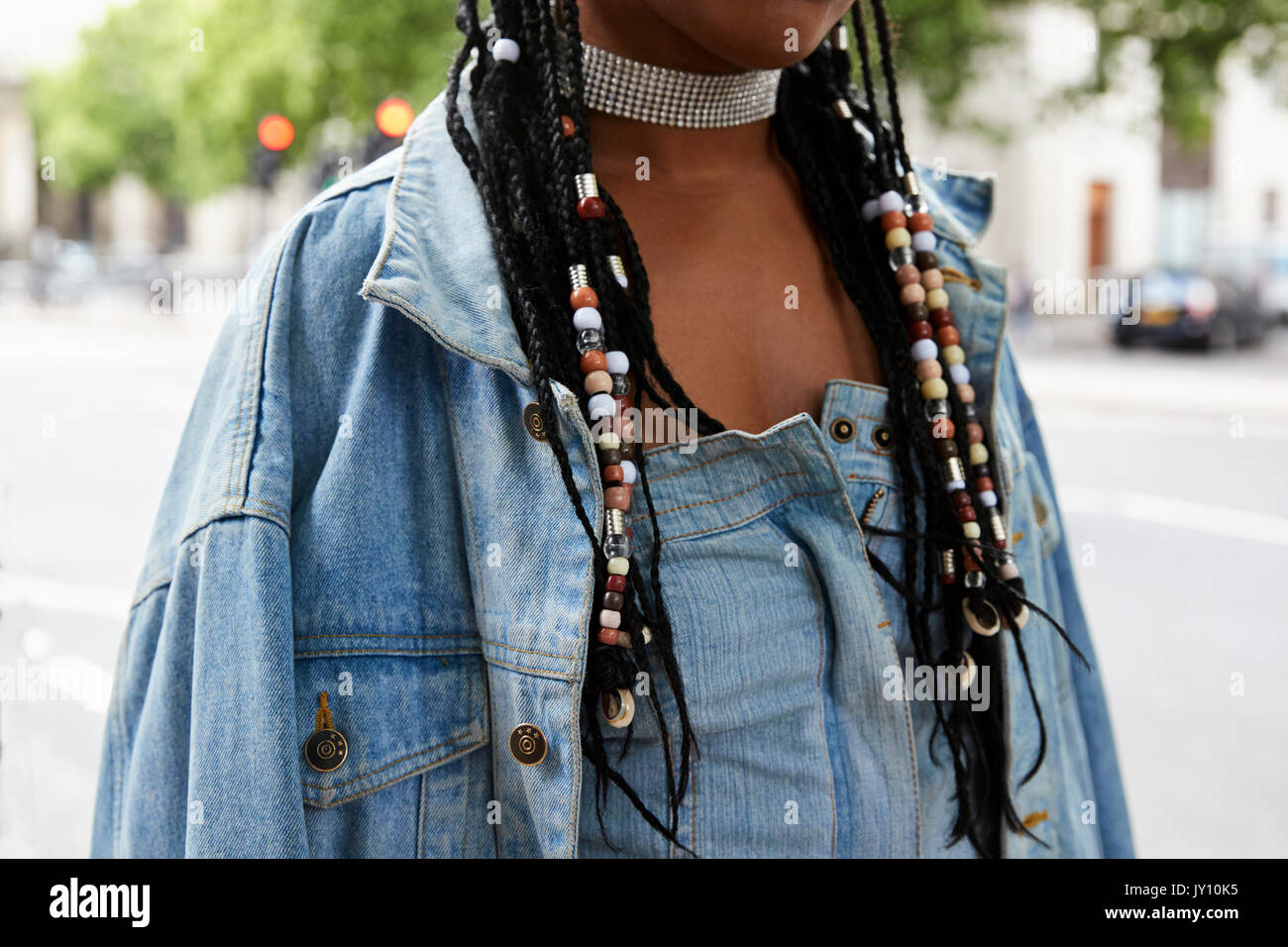 Woman with braided hair wearing denim and a diamante choker Stock Photo