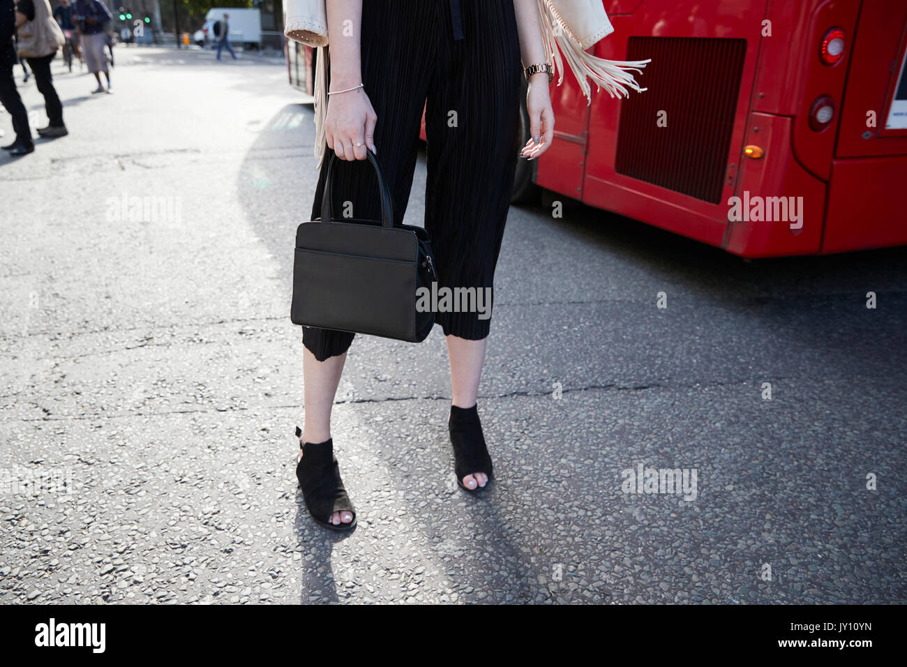 Low section of woman in black culottes and peep toe shoes Stock Photo