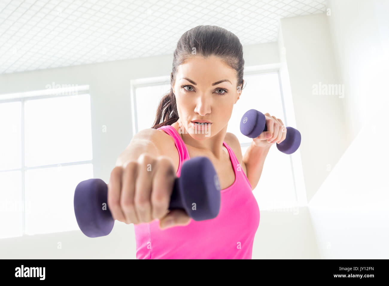 Caucasian woman lifting weights Stock Photo