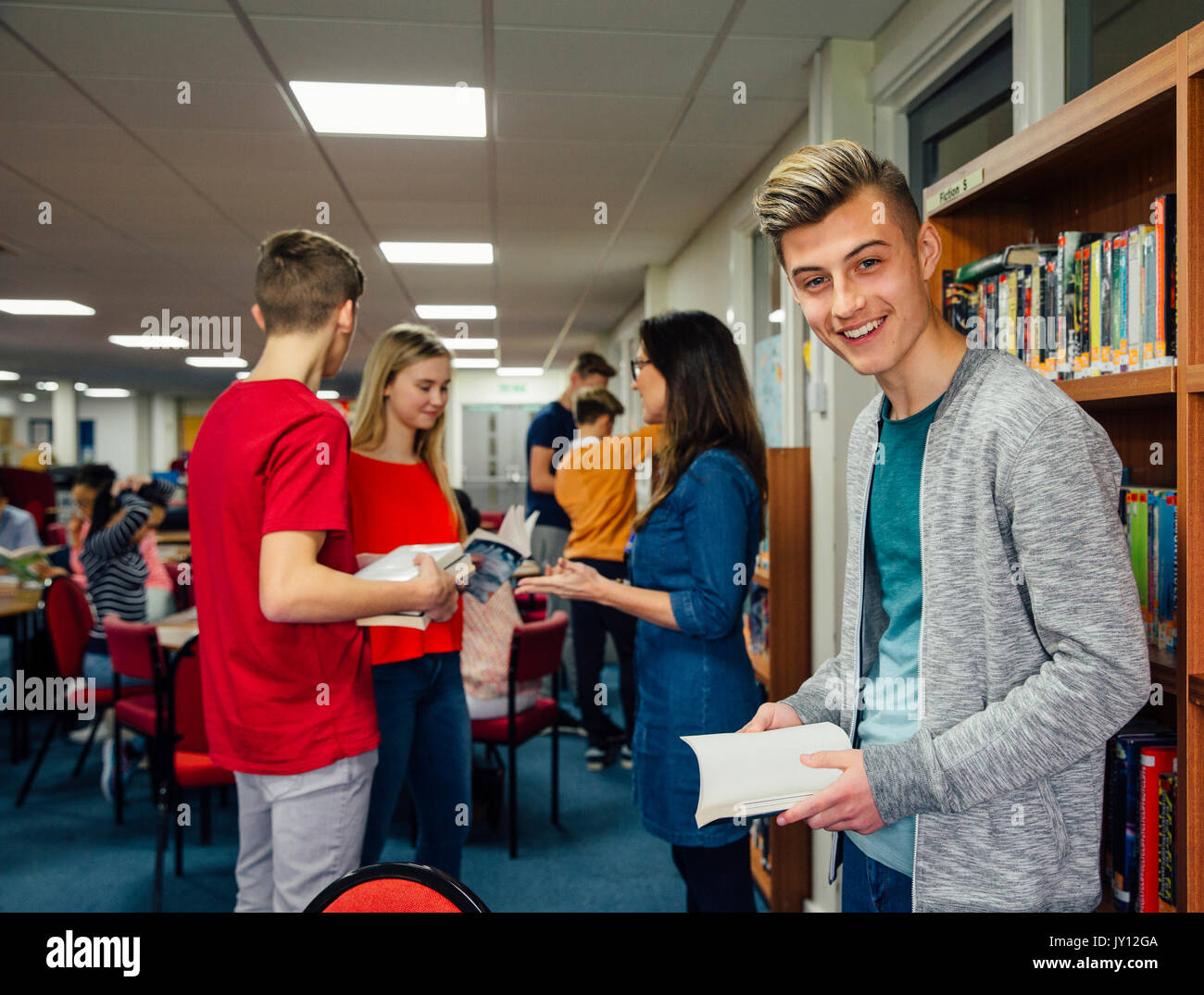 Reading Seriously Teenage students looking book hi-res stock photography and images - Alamy