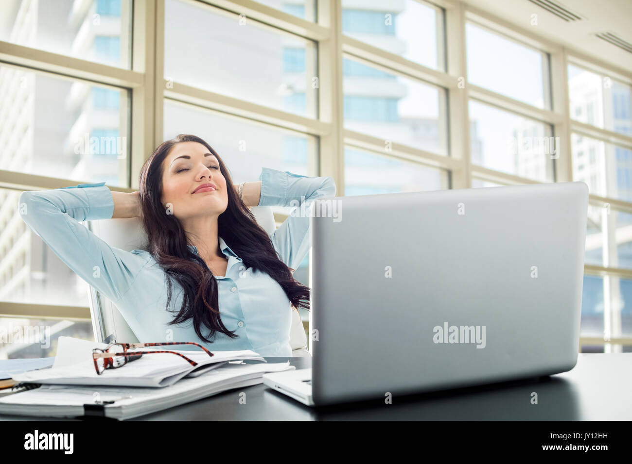 Caucasian businesswoman unwinding in office Stock Photo