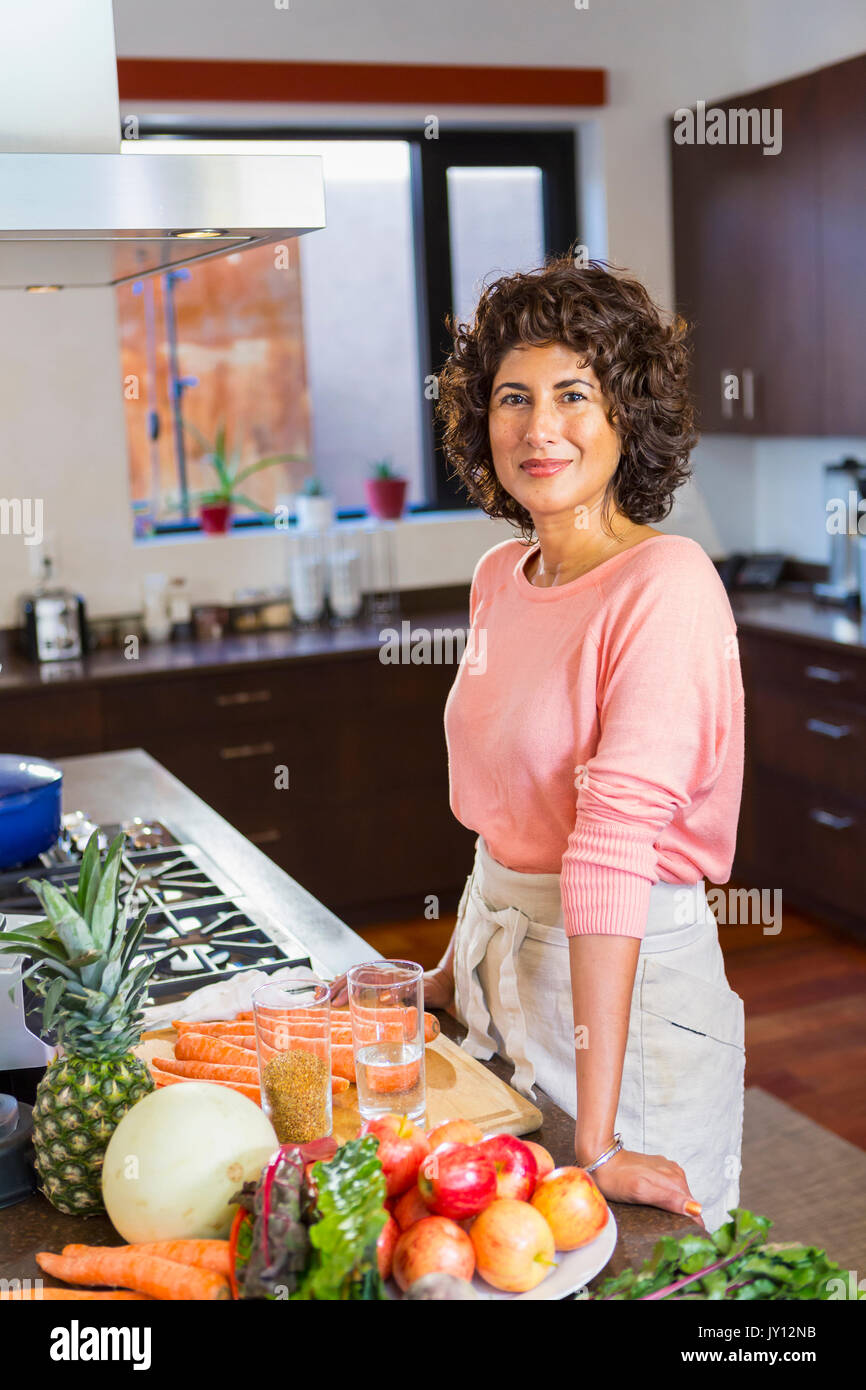 portrait of Hispanic woman in domestic kitchen Stock Photo