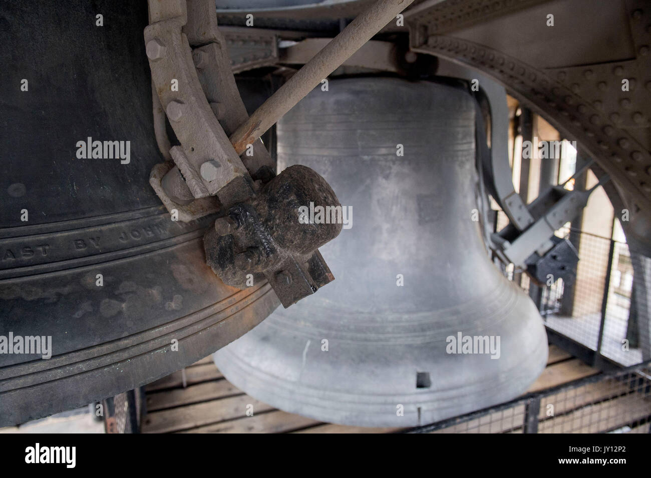 The hammer on one of the four smaller bells surrounding Big Ben (right), which will be removed and cleaned during the renovation work on the Elizabeth Tower at the Palace of Westminster, London. Stock Photo