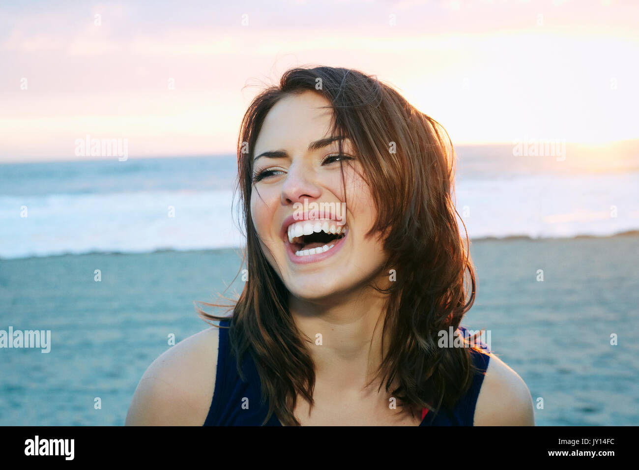 Portrait of laughing Caucasian woman at beach Stock Photo