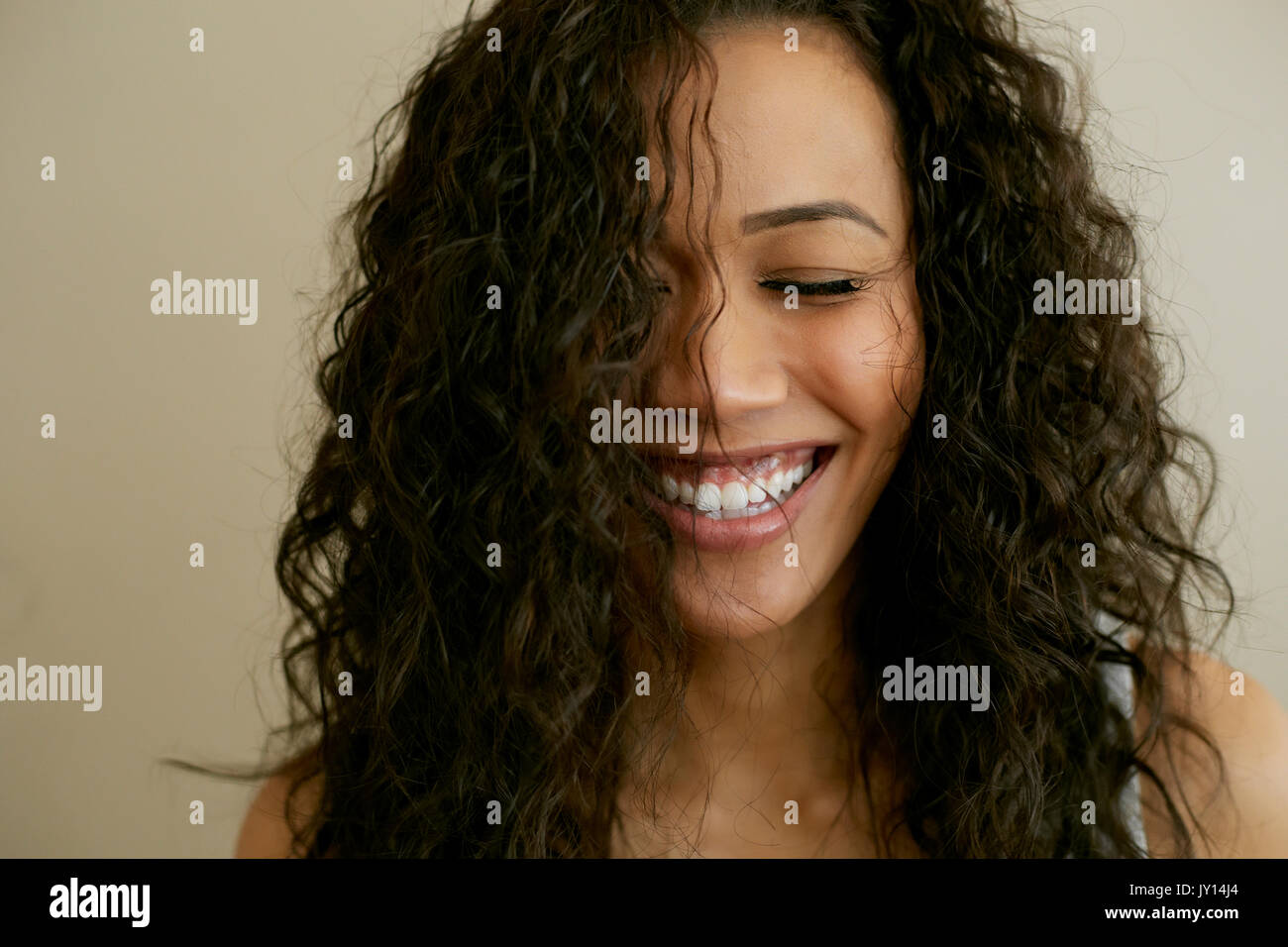 Portrait of laughing Mixed Race woman with eyes closed Stock Photo