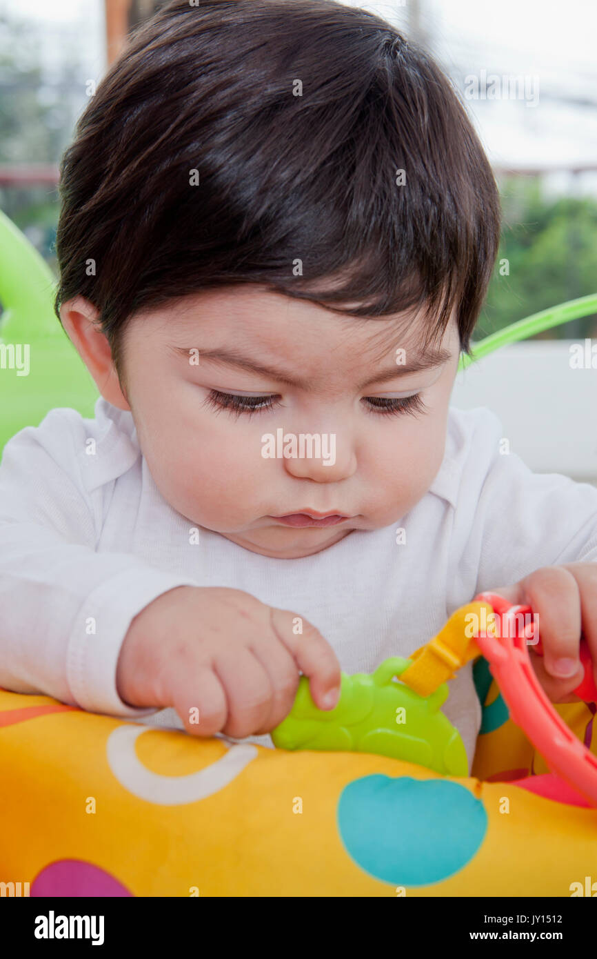 Hispanic baby boy playing with toy Stock Photo