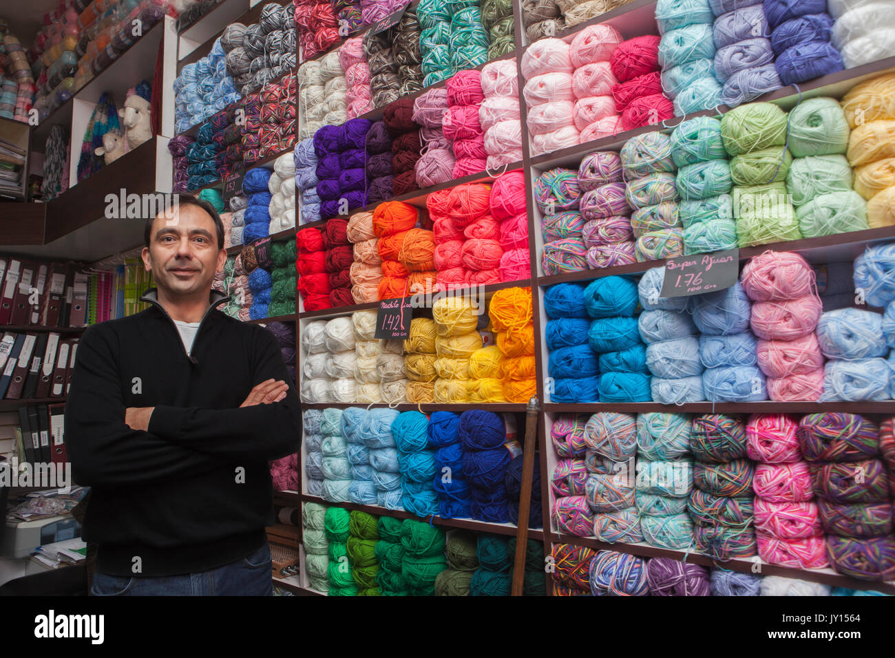 Mixed Race man posing at yarn store Stock Photo