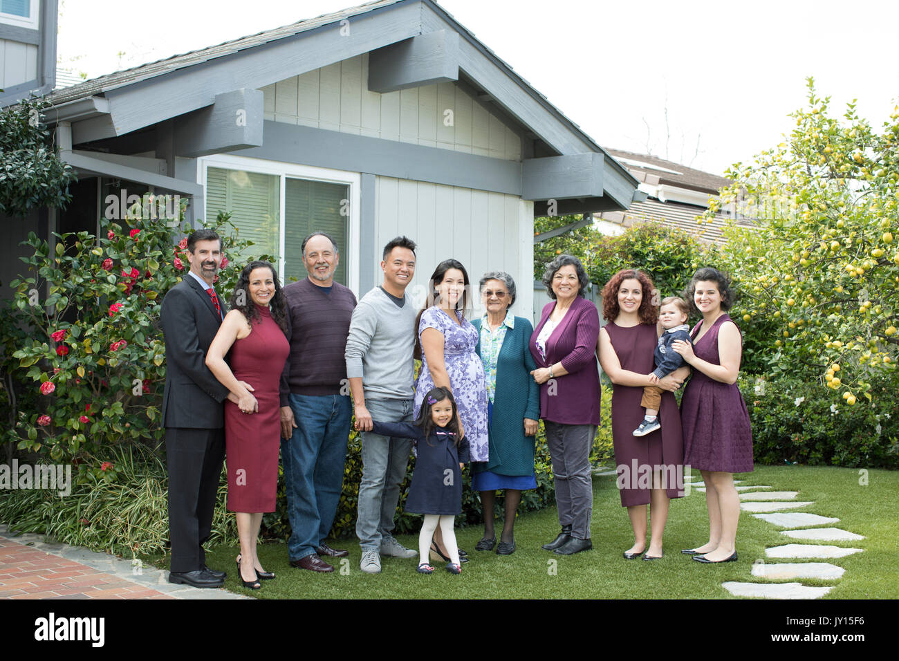 Multi-generation family posing near house Stock Photo