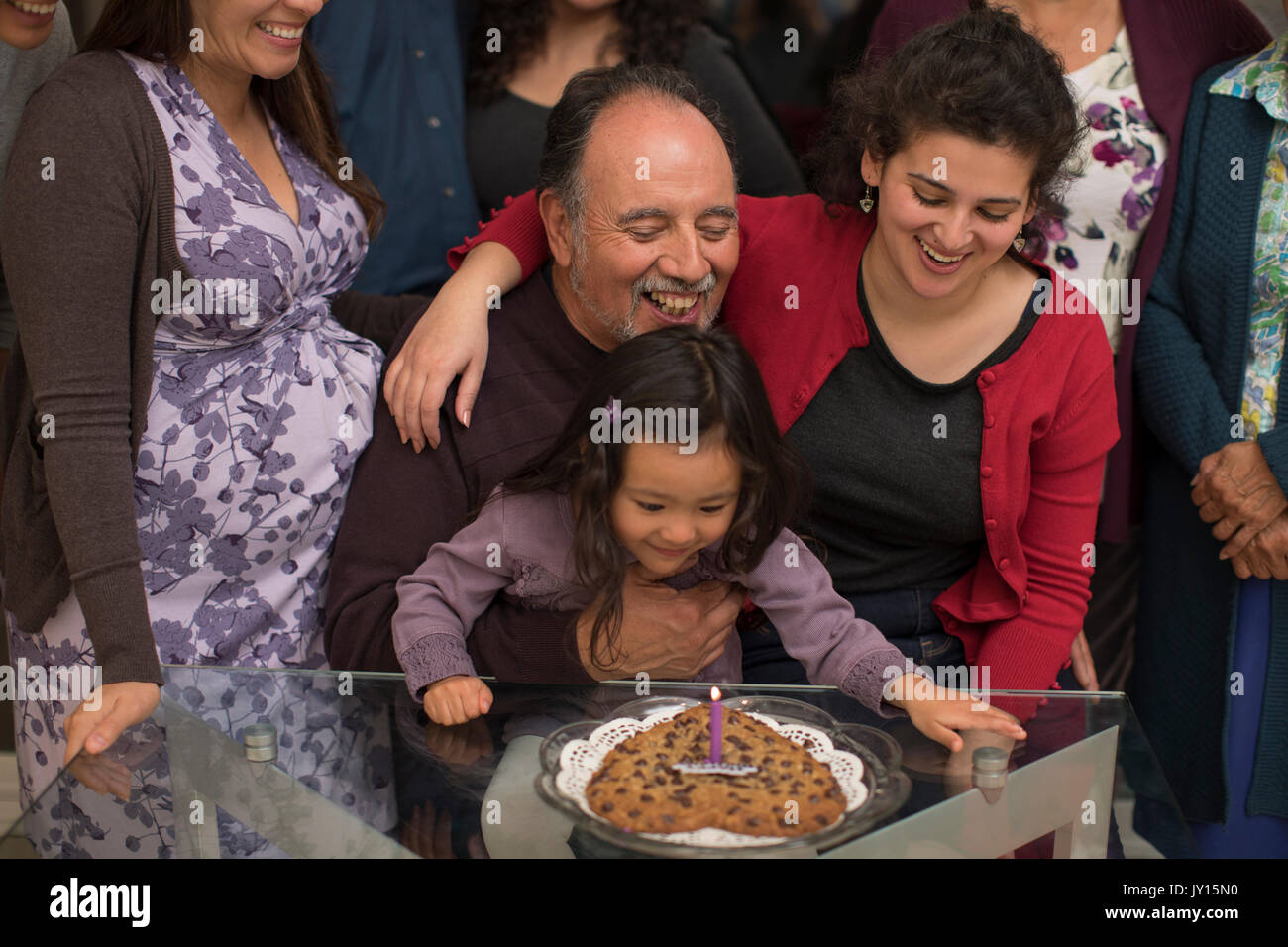 Multi-generation family celebrating birthday of older man Stock Photo