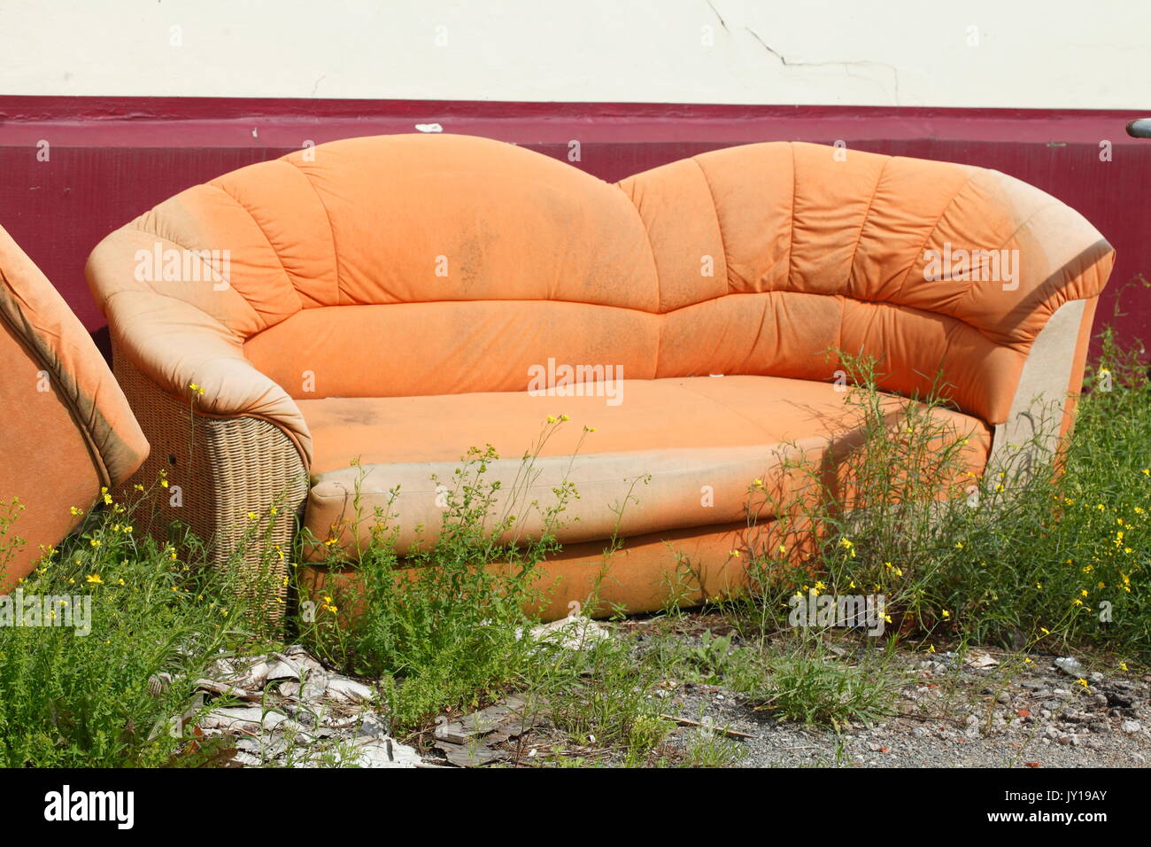old orange couch for bulky refuse collection Stock Photo Alamy