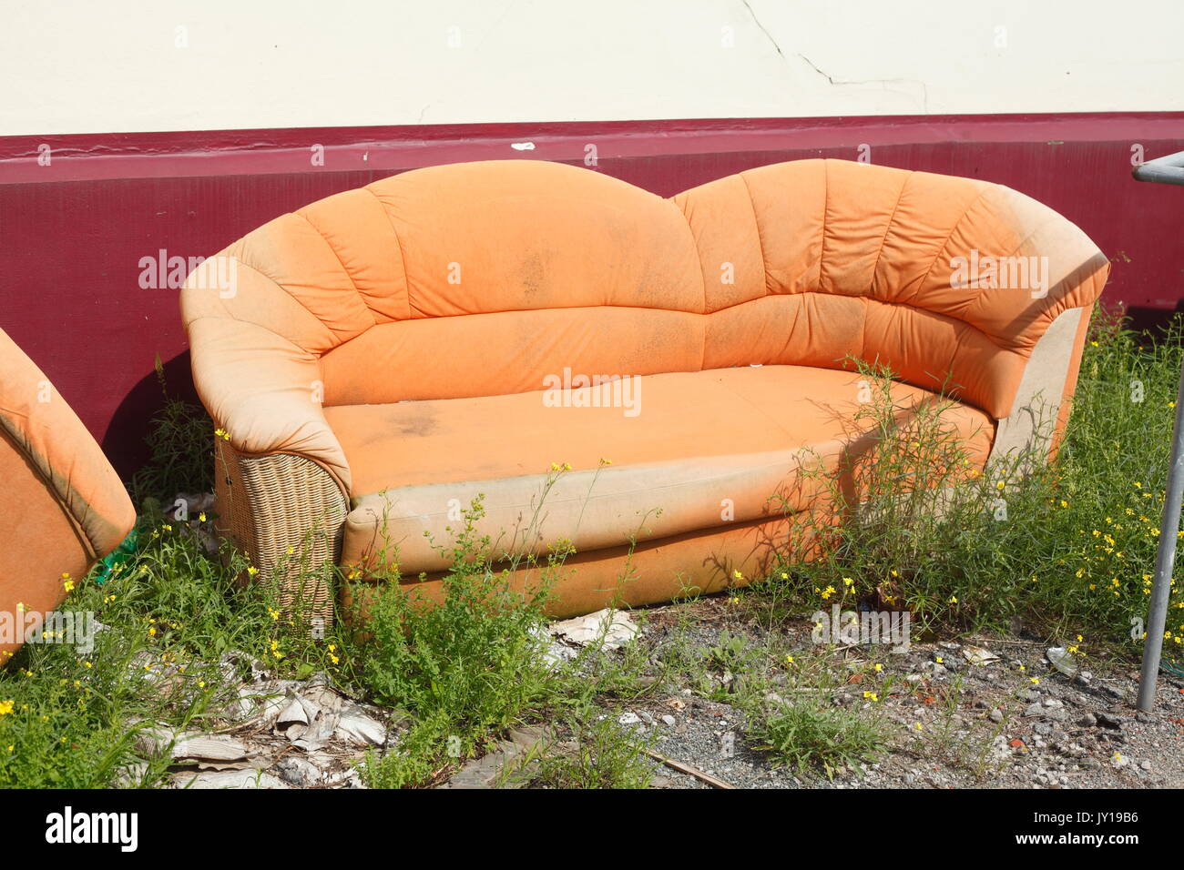 old orange couch for bulky refuse collection Stock Photo