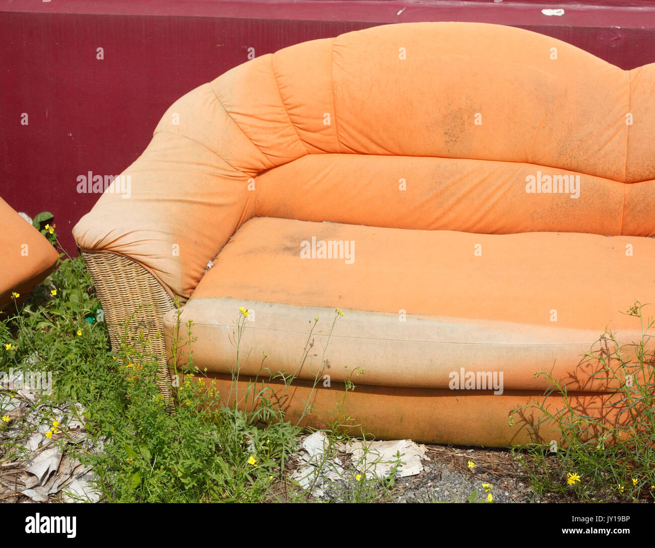 old orange couch for bulky refuse collection Stock Photo