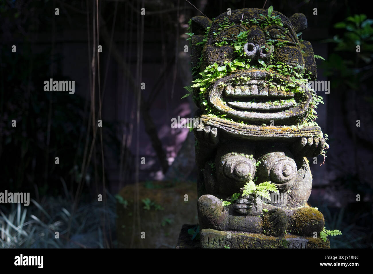 Monkey spirit sculpture with moss in Arma Museum on the right, Ubud, Bali, Indonesia Stock Photo