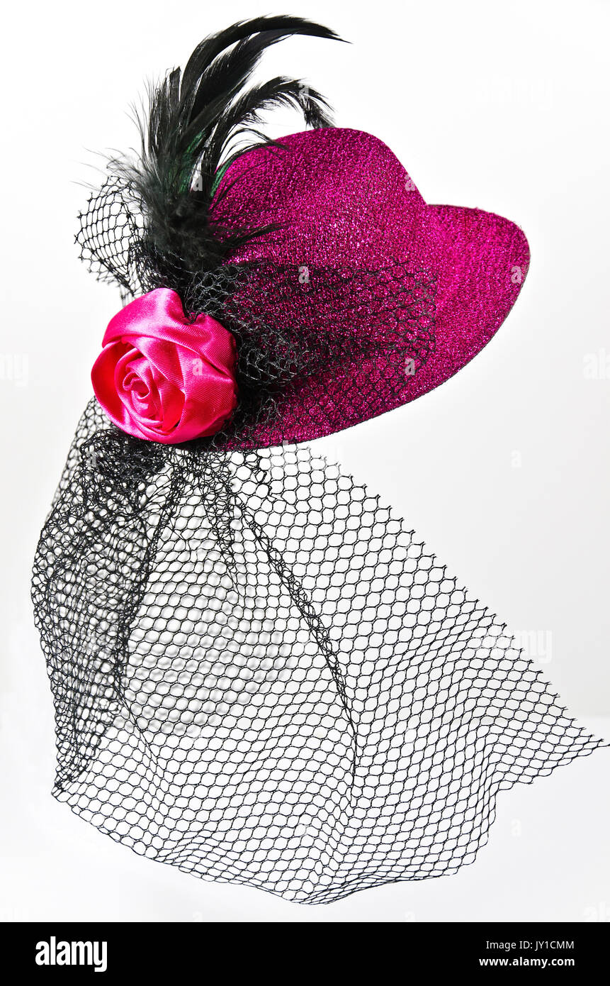 Bright pink  lady's hat with a black veil isolated on white - a carnival costume accessory Stock Photo