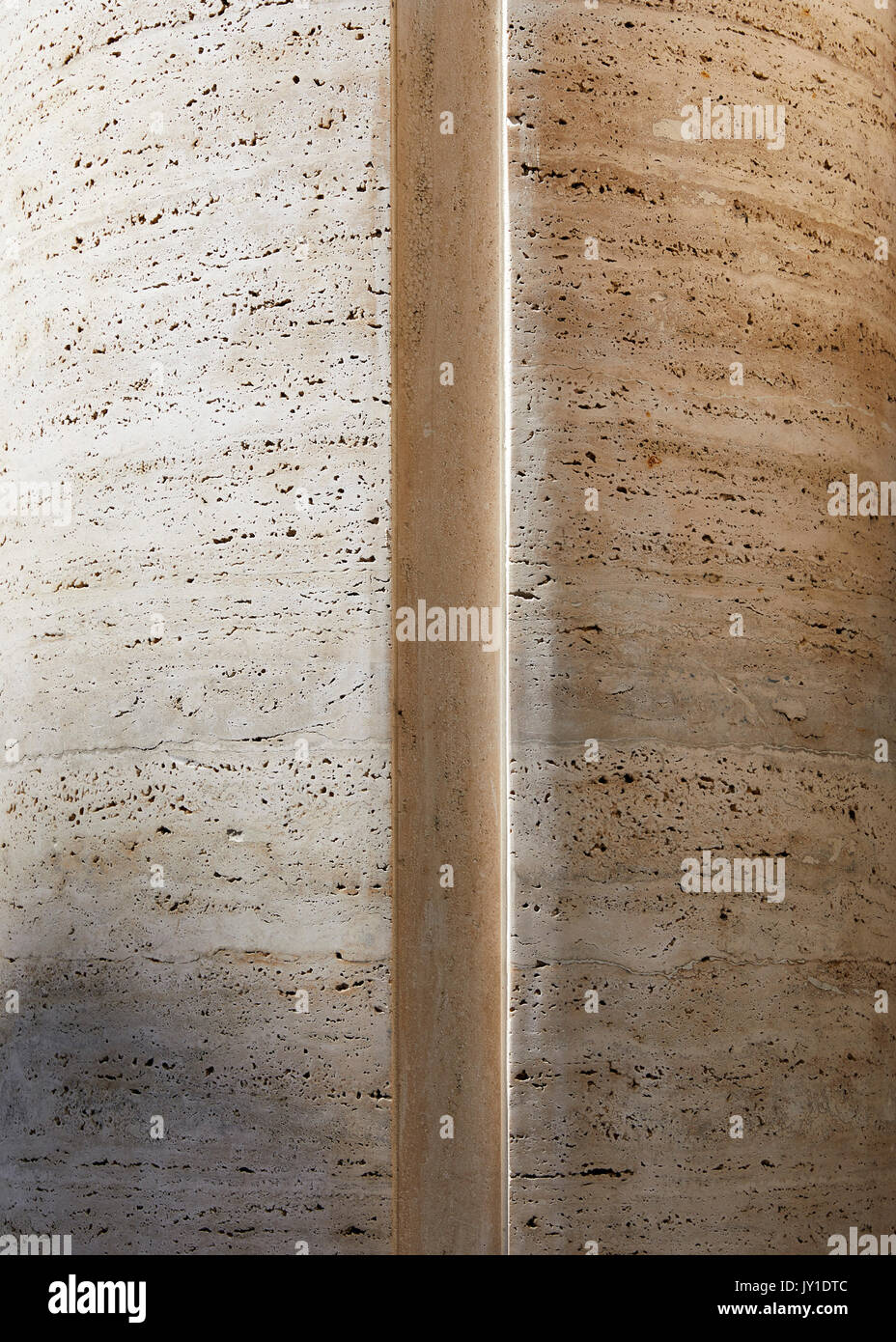 Abstract detail of a travertine column with sunlight and shade