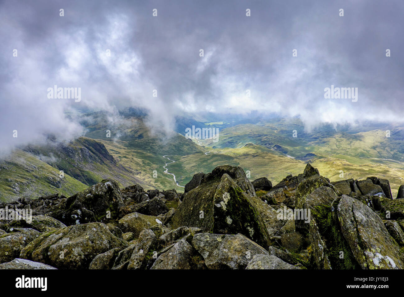 Beneath the clouds on the summit of Bowfell, Lake District Stock Photo