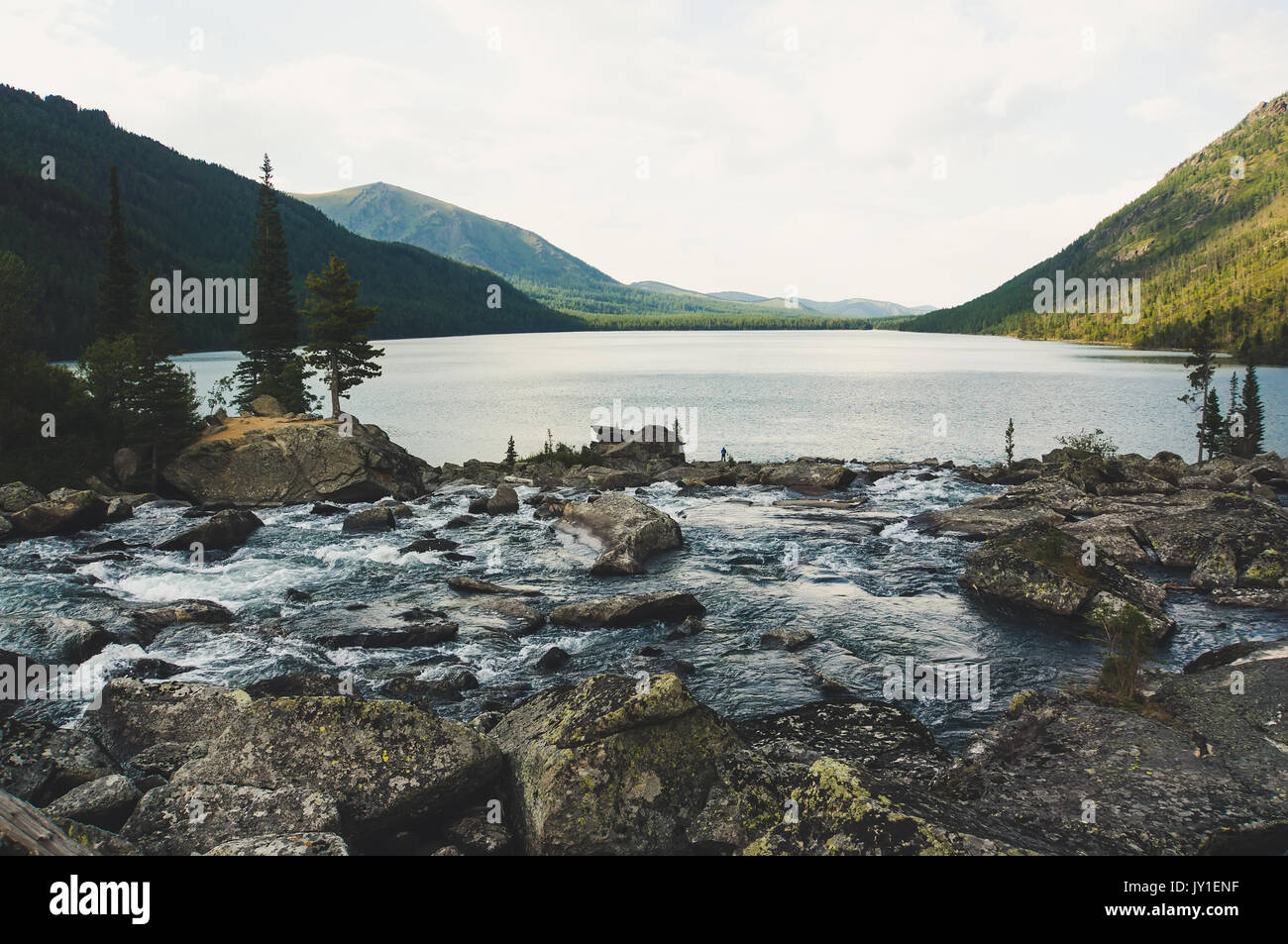 River flow with huge stone. The river flows into the Multinskoe lake. Noise between the two lakes. Altay Russia Stock Photo
