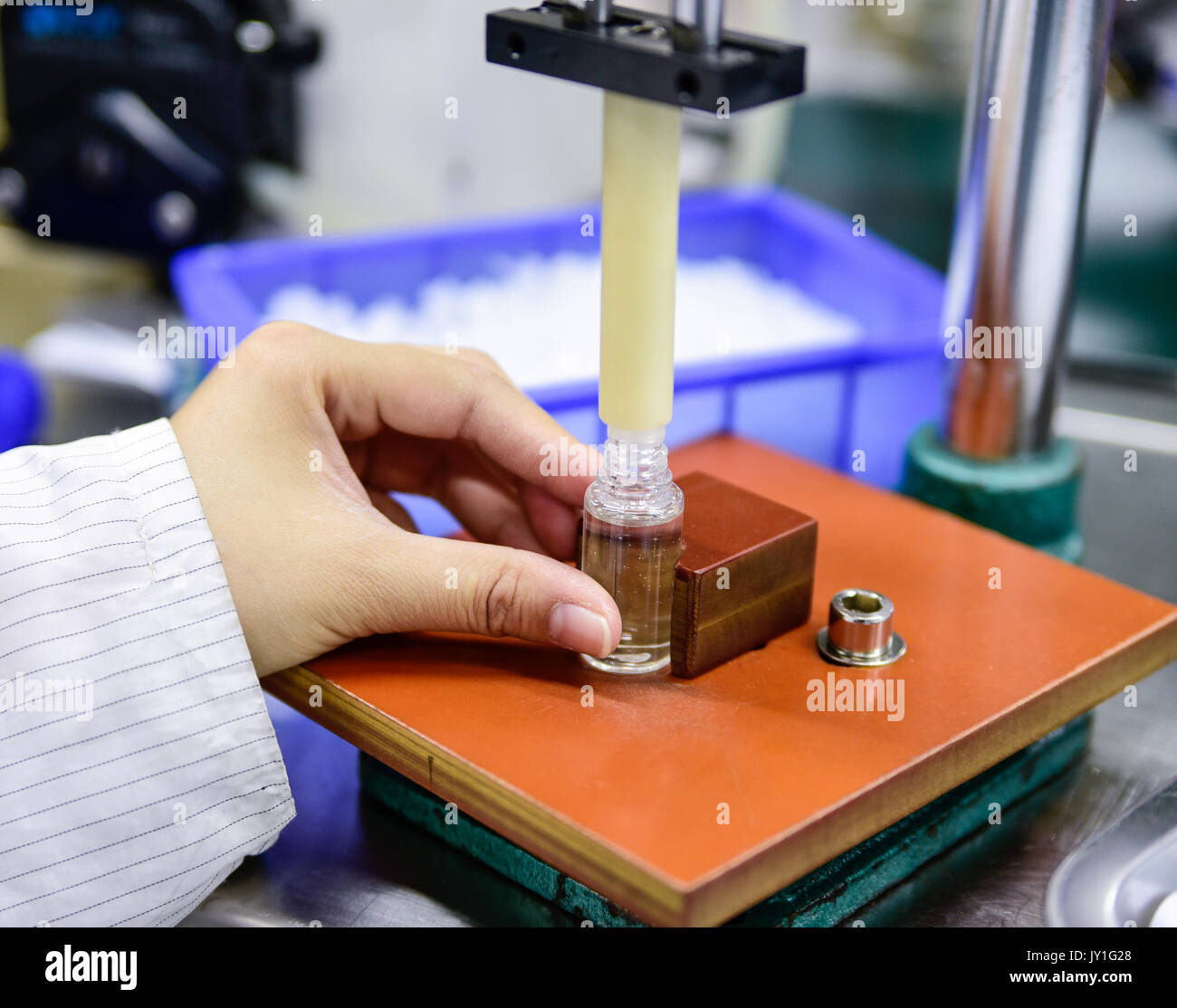 Filling the bottle with e-liquid at factory Stock Photo